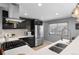 Modern kitchen with stainless steel appliances, white countertops, and dark wood cabinets at 2572 Beech Ct, Golden, CO 80401