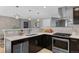 Modern kitchen features stainless steel appliances, dark cabinets, and stylish pendant lighting at 2572 Beech Ct, Golden, CO 80401