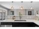 Well-lit kitchen with updated sink, stainless steel appliances, and convenient counter seating at 2572 Beech Ct, Golden, CO 80401