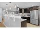 Open kitchen with stainless steel appliances, white countertops, and dark wood cabinets at 2572 Beech Ct, Golden, CO 80401