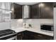 Updated kitchen featuring dark wood cabinets, stainless steel appliances, and modern countertops at 2572 Beech Ct, Golden, CO 80401