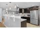 Bright kitchen boasts stainless steel appliances, dark wood cabinets, and ample counter space at 2572 Beech Ct, Golden, CO 80401