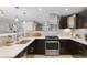 Modern kitchen with stainless steel appliances, white countertops, and dark wood cabinets at 2572 Beech Ct, Golden, CO 80401