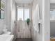 Modern tiled shower with light gray wood look planks and a window at 2572 Beech Ct, Golden, CO 80401