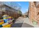 Side yard with colorful storage containers and potential for additional landscaping or outdoor activities at 2572 Beech Ct, Golden, CO 80401