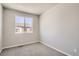 Neutral bedroom with plush carpet, a window and bright white walls at 6827 Huddersfield Ln, Castle Pines, CO 80108