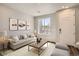 Cozy living room with sofa, large window, and modern decor at 6827 Huddersfield Ln, Castle Pines, CO 80108