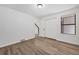 Bedroom with a large window, and a closet. Featuring new vinyl floors and neutral paint at 225 E 8Th Ave # A2, Longmont, CO 80504