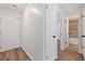 Hallway with views to front door, and a bathroom with tile details and new fixtures at 225 E 8Th Ave # A2, Longmont, CO 80504