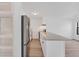 Modern kitchen featuring stainless steel refrigerator and breakfast bar with granite counters at 225 E 8Th Ave # A2, Longmont, CO 80504