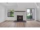 Bright living room with fireplace, wood flooring, and sliding glass doors with natural light at 225 E 8Th Ave # A2, Longmont, CO 80504