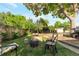 Cozy backyard featuring a fire pit, mature trees, and a grassy area perfect for outdoor entertaining at 2520 Dover Ct, Lakewood, CO 80215