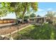 Backyard boasts a mature tree, a cozy outdoor seating area, and plenty of space for relaxation and recreation at 2520 Dover Ct, Lakewood, CO 80215