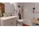 Bright bathroom featuring a white vanity, toilet, shower with a tub at 2520 Dover Ct, Lakewood, CO 80215