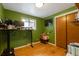 Cozy bedroom with hardwood floors, closet and large window with view of yard at 2520 Dover Ct, Lakewood, CO 80215