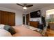 This bedroom features a ceiling fan, TV and a glimpse into the connected bathroom at 2520 Dover Ct, Lakewood, CO 80215
