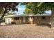 Charming brick home featuring a well-maintained front yard with mature trees and covered entry at 2520 Dover Ct, Lakewood, CO 80215