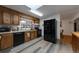 Bright kitchen featuring updated appliances, wood cabinets, and a functional layout at 2520 Dover Ct, Lakewood, CO 80215