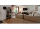 Spacious living area with hardwood floors, large sofa, TV, and unique decor at 2520 Dover Ct, Lakewood, CO 80215