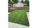 This backyard features a pristine lawn, ornamental grasses, and a concrete patio for dining and relaxing at 8700 S Ammons St, Littleton, CO 80128