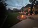Inviting backyard with fire pit, patio seating, and outdoor lighting, perfect for entertaining in the evening at 8700 S Ammons St, Littleton, CO 80128