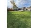 Expansive backyard featuring a lush lawn, a detached garage, and a deck perfect for outdoor gatherings at 8700 S Ammons St, Littleton, CO 80128