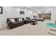 Spacious basement area featuring a seating area with leather couches and a bed at 8700 S Ammons St, Littleton, CO 80128