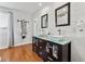 Modern bathroom featuring a double vanity, shiplap walls, and sleek fixtures at 8700 S Ammons St, Littleton, CO 80128