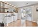 Bright dining area features a sliding glass door, wood floors, and stylish decor at 8700 S Ammons St, Littleton, CO 80128