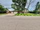 Charming two-story home featuring a beautifully manicured lawn and a two car garage at 8700 S Ammons St, Littleton, CO 80128