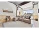 Finished garage includes a sectional sofa, epoxy floors, wood paneling and garage door to outside at 8700 S Ammons St, Littleton, CO 80128