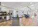 Bright kitchen with stainless steel appliances, island, and an adjacent dining area at 8700 S Ammons St, Littleton, CO 80128