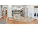 Kitchen island with granite countertop, stainless steel appliances, and white cabinets at 8700 S Ammons St, Littleton, CO 80128