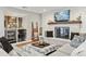 Inviting living room features a white brick fireplace, built-in shelves, and modern decor at 8700 S Ammons St, Littleton, CO 80128