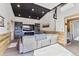 Stylish living room features vaulted ceiling, hardwood floors, and recessed lighting at 8700 S Ammons St, Littleton, CO 80128