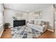 Inviting living room featuring a stylish couch, decorative rug, and tasteful decor at 8700 S Ammons St, Littleton, CO 80128