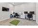 Spacious office with room for two workspaces, neutral walls, contemporary lighting, and a television for presentations at 8700 S Ammons St, Littleton, CO 80128