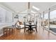 Bright sunroom with vaulted ceilings, skylights, and an adjacent dining area at 8700 S Ammons St, Littleton, CO 80128