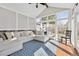 Cozy sunroom with a vaulted ceiling, large windows, and a comfortable sectional sofa, perfect for relaxation at 8700 S Ammons St, Littleton, CO 80128