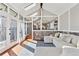 Inviting sunroom showcasing stone accents, lots of windows and a cozy seating area at 8700 S Ammons St, Littleton, CO 80128