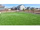 Large backyard area with artificial turf and a fire pit area in a fenced yard at 16722 Chilton Dr, Mead, CO 80542