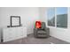 Bright bedroom with a gray armchair, a dresser, and a window with natural light at 16722 Chilton Dr, Mead, CO 80542