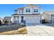 Charming two-story home with a well-manicured lawn, attached two-car garage, and a welcoming front porch at 16722 Chilton Dr, Mead, CO 80542