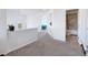 Spacious hallway with carpet flooring leads to various rooms in the house at 16722 Chilton Dr, Mead, CO 80542