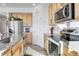 Kitchen featuring wood cabinets, stainless steel appliances and granite countertops at 16722 Chilton Dr, Mead, CO 80542