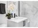 Modern bathroom with marble tile and black accents at 4389 Zenobia St, Denver, CO 80212