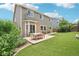 Backyard featuring patio, green lawn, and home exterior at 10115 Cook St, Thornton, CO 80229
