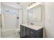 Bathroom featuring black vanity, modern lighting, and tiled shower at 10115 Cook St, Thornton, CO 80229
