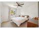 Bright bedroom with a ceiling fan, light walls, and a window at 10115 Cook St, Thornton, CO 80229