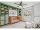 Bedroom with crib, shelving unit, chair, and window at 10115 Cook St, Thornton, CO 80229